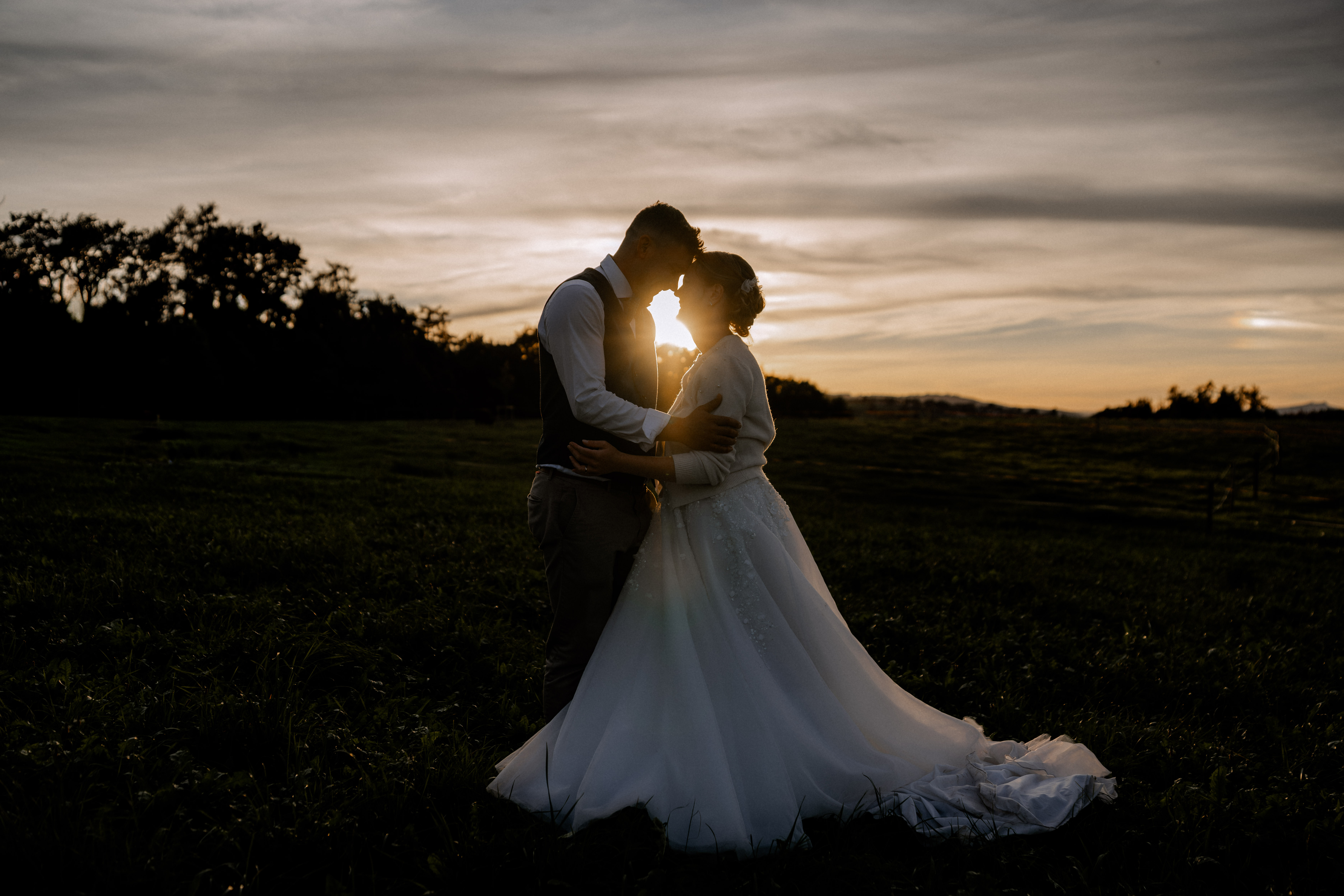 Brautpaar umarmt sich im Sonnenuntergang bei einer Hochzeitsfotografie. - Hochzeitsfotograf Pablo aus Thurgau